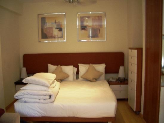 The bed in the studio apartment