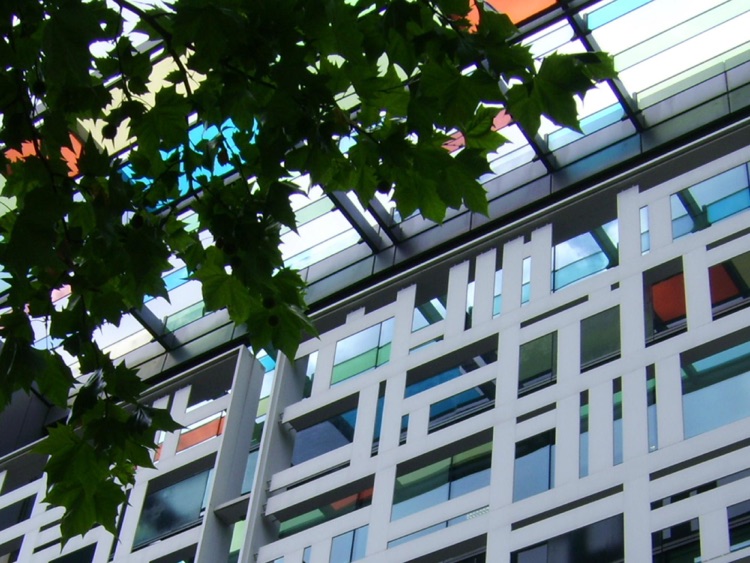 Sunshine on coloured glass panels and aluminium screen.