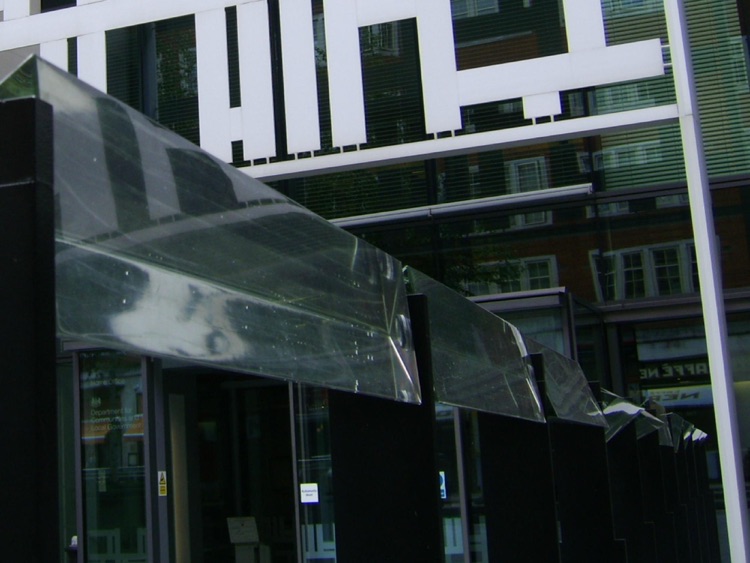 Large Prisms reflect the sun and the colored glass onto people and other surfaces.