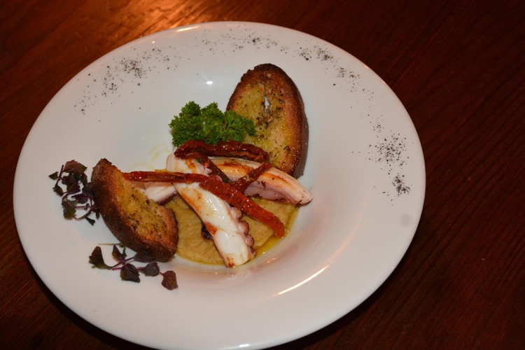 Pan fried octopus on a chiockpeas puree with sun dried tomatoes