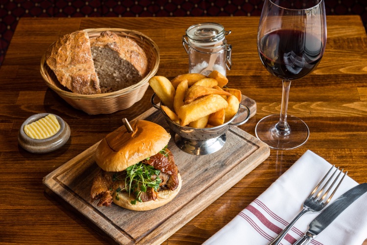 Confit Duck Burger - Roasted Confit duck leg, Smoky Tomatoes, Red Onion Jam & Roquette salad.