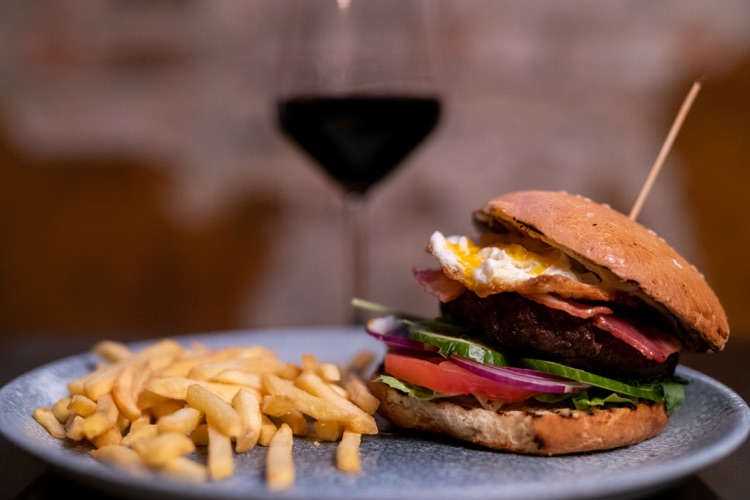 Nowina ribeye steak burger with fried egg and vegetables