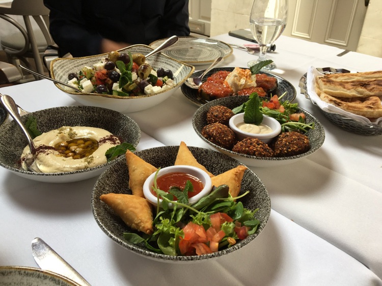 Selection of hot starters and feta salad