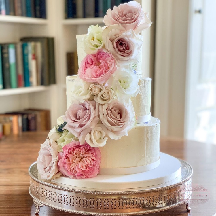 3 tier Buttercream iced cake decorated with fresh flowers
